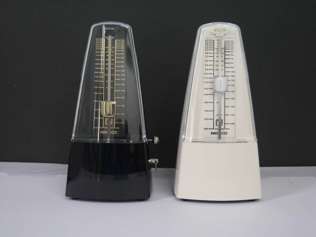 2 mechanic metronomes standing next to each other from a studio magazine