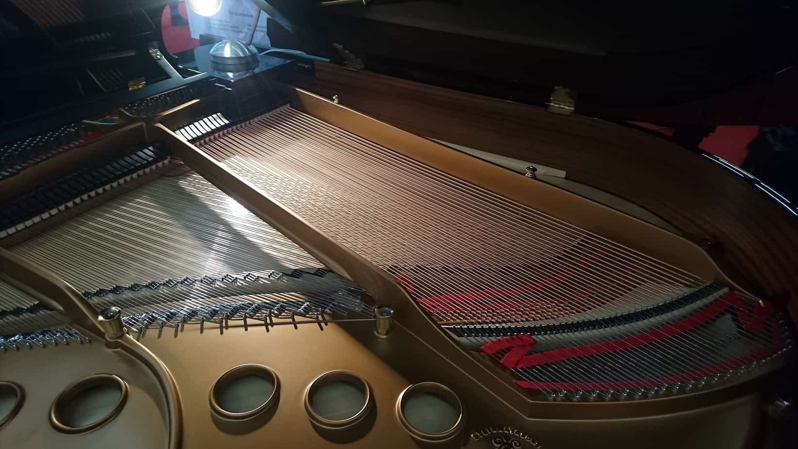 the golden corpus of a Steinway & Sons B211 by a studio magazine